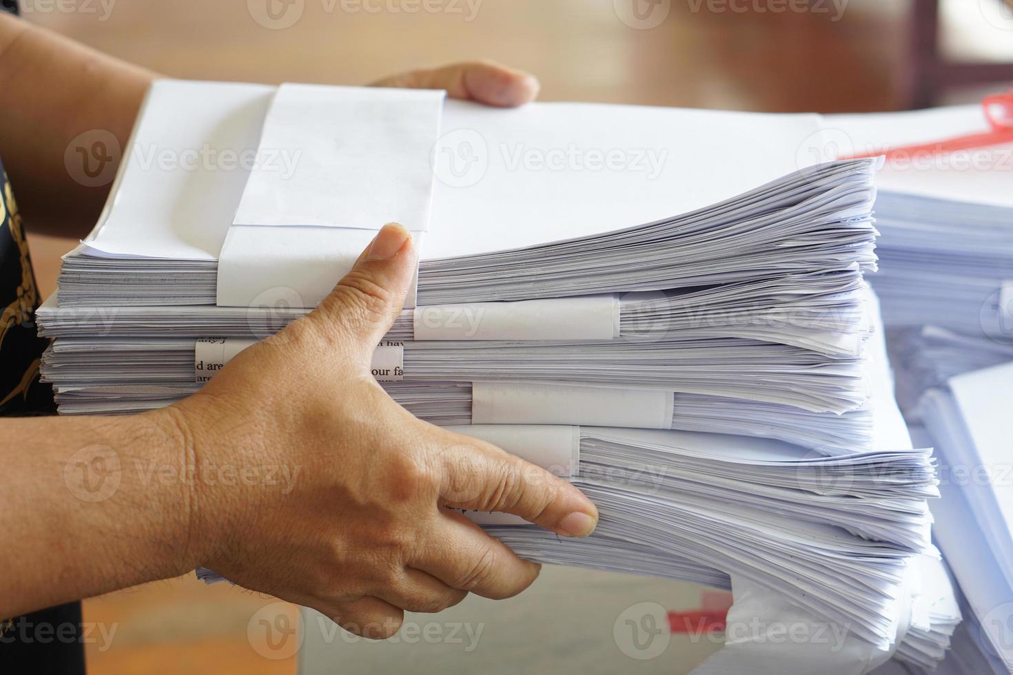 Closeup hands hold stack of used paper to recycle or combine to use next time to print out both sides of paper. Concept, eco friendly activity for environment, reuse paper. photo
