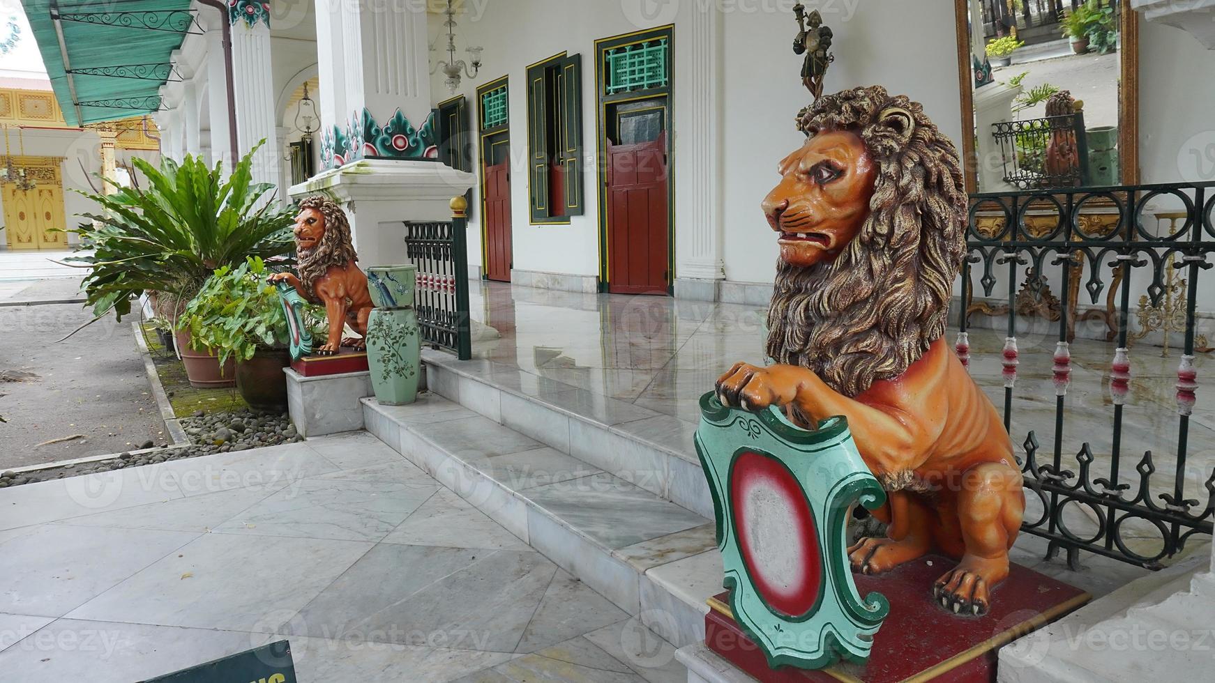 The statue of a lion in the Yogyakarta Palace symbolizes the royal power of the palace in Java photo