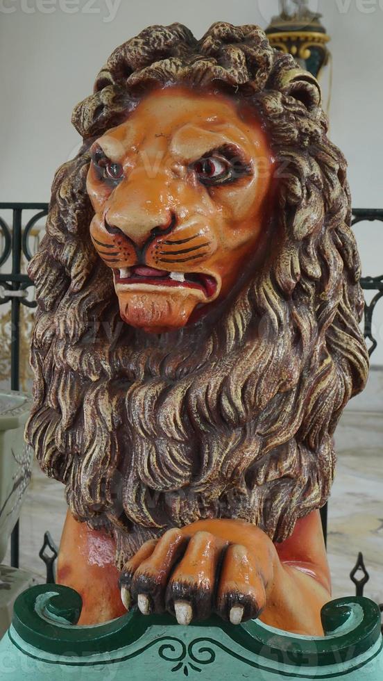 The statue of a lion in the Yogyakarta Palace symbolizes the royal power of the palace in Java photo