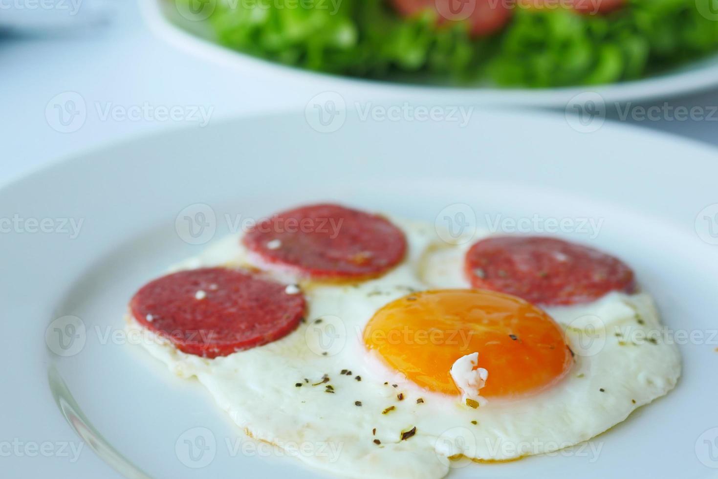 fried egg mixed with sausage on a plate photo