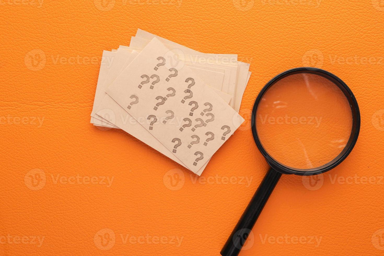 high angle view of question mark on paper on office desk photo