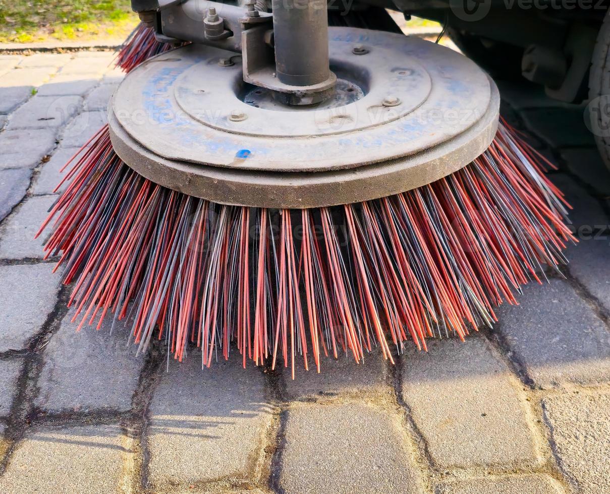 Close-up sweeper machine cleaning. Concept clean streets from debris. photo