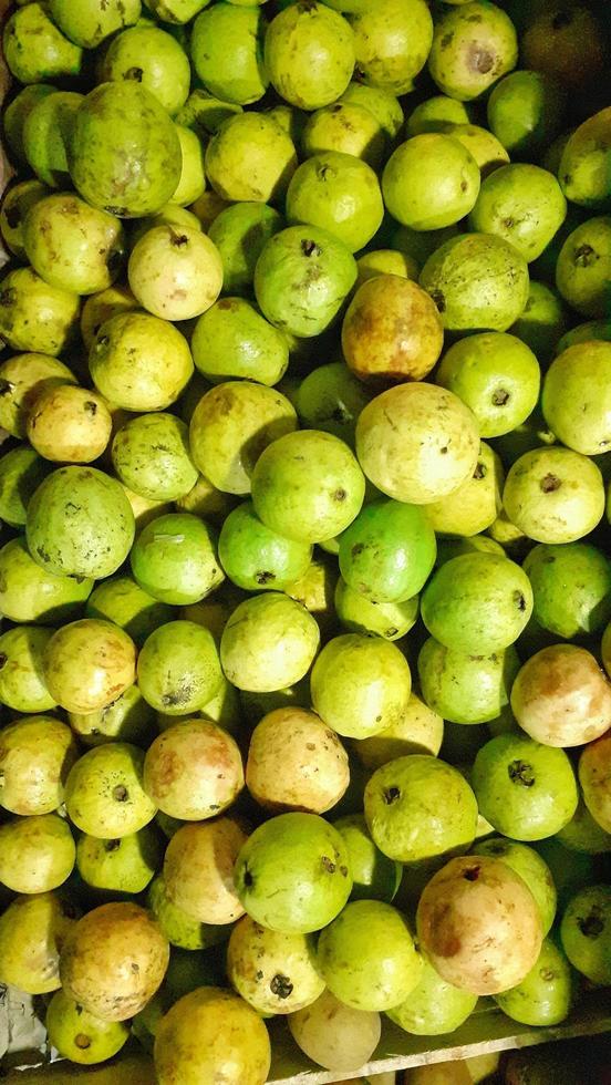 Guava fruit on a wooden shelf for sale. photo