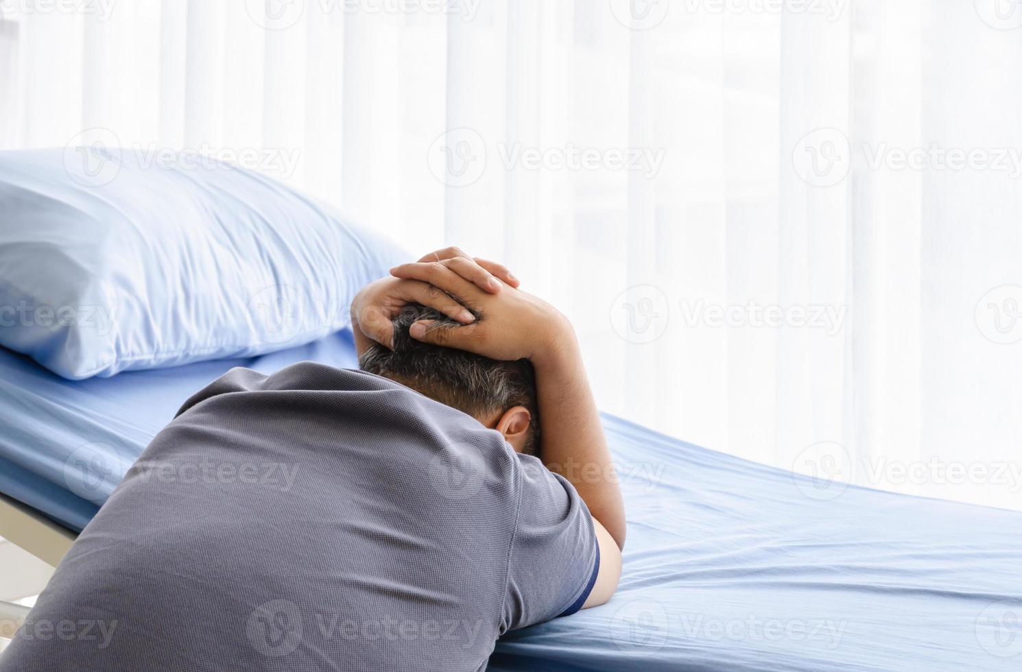 Elderly man feel grief suffer on patient bed for gone wife in hospital photo