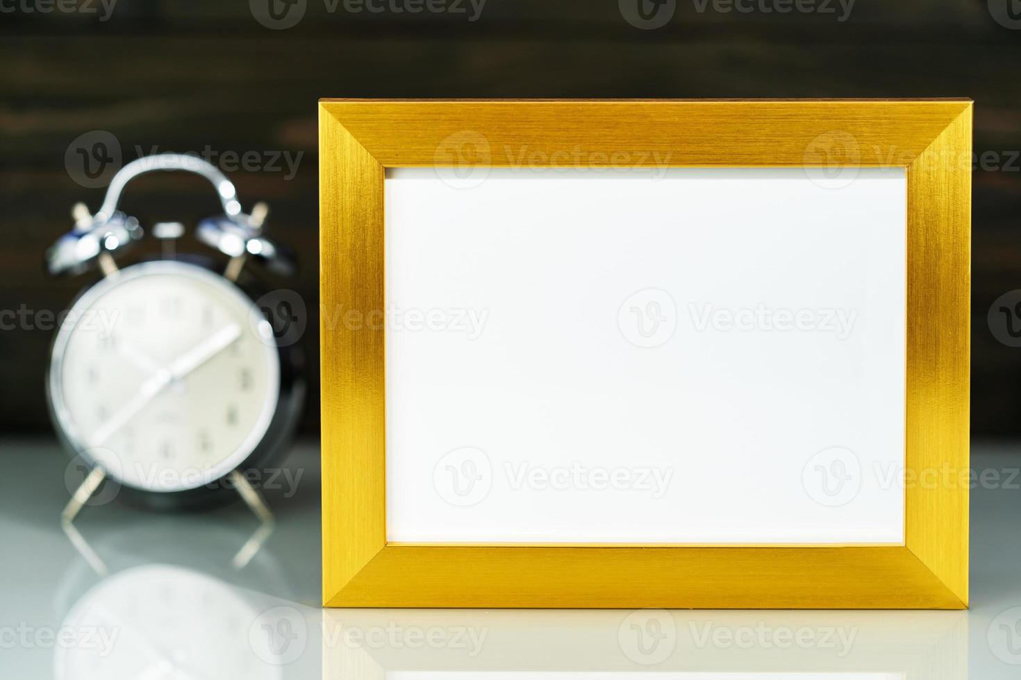 Mockup with golden frame and alarm clock photo