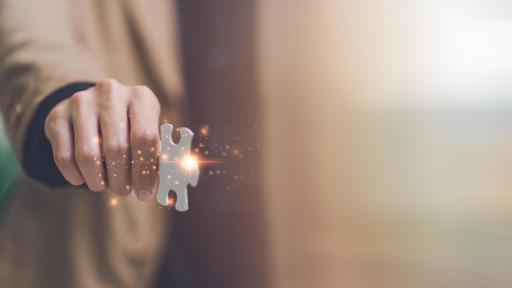 Businessman holding a puzzle piece to find a business solution ,visionary decisions for success,finding a business solution,success and strategy concept ,solution and leadership strategies photo