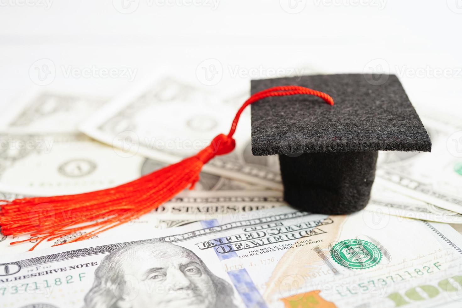 Graduation gap hat on US dollar banknotes money, Education study fee learning teach concept. photo