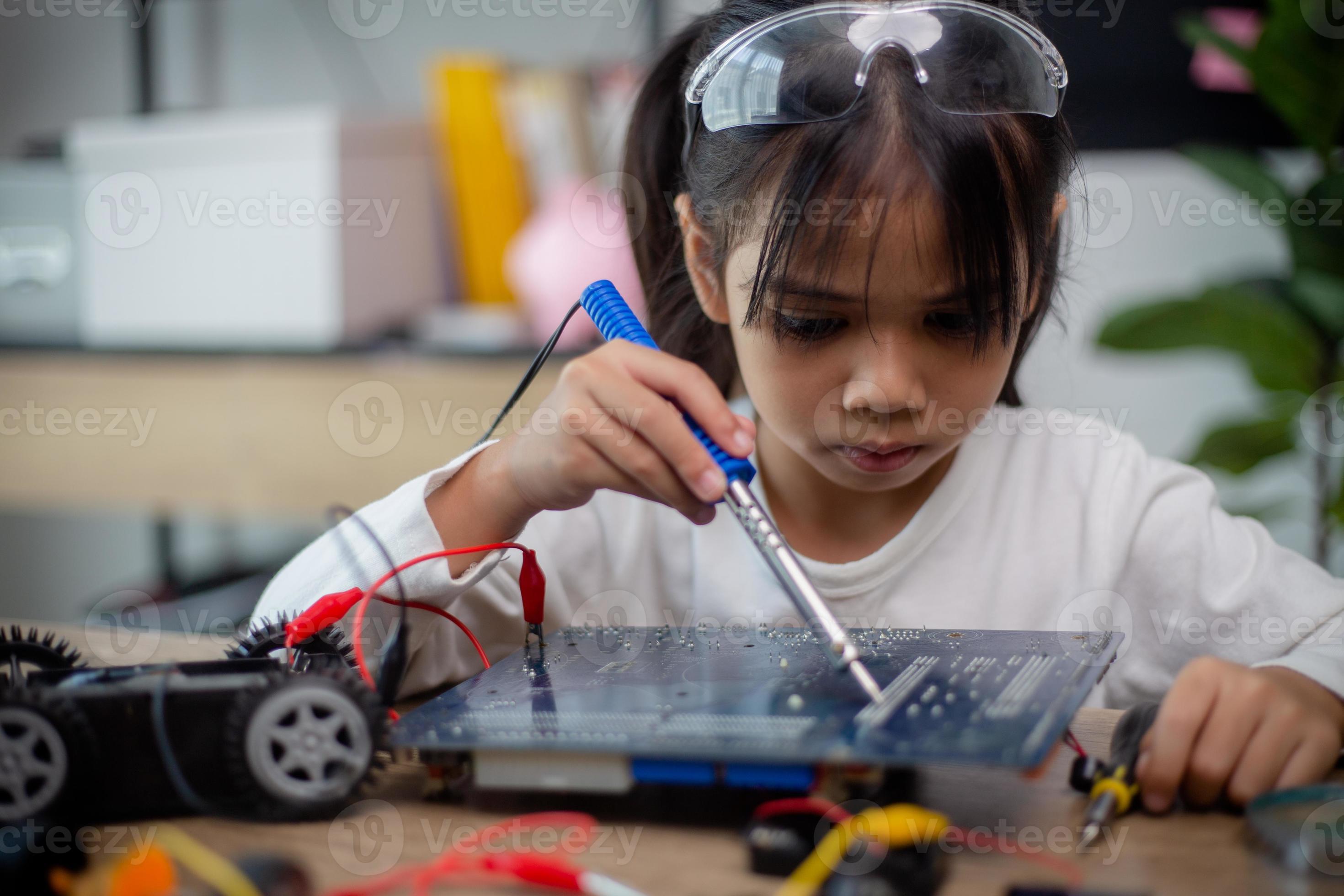 asia-students-learn-at-home-in-coding-robot-cars-and-electronic-board