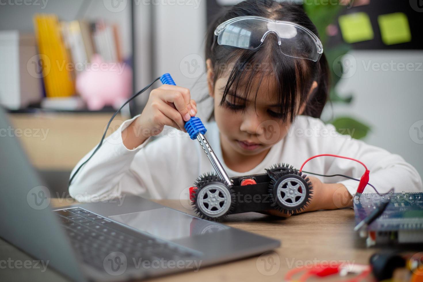 Asia students learn at home in coding robot cars and electronic board cables in STEM, STEAM, photo