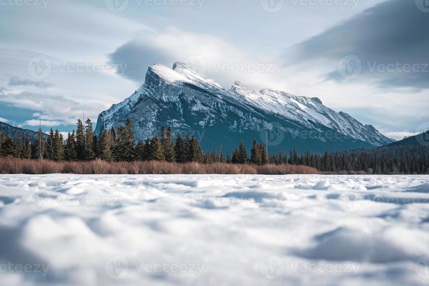 Frozen Vermillion Lake with Mount Rundle and snow covered in winter on sunny day at Banff national park photo