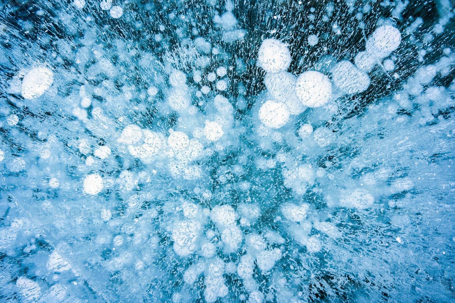 Natural ice bubbles on frozen lake in wintertime photo