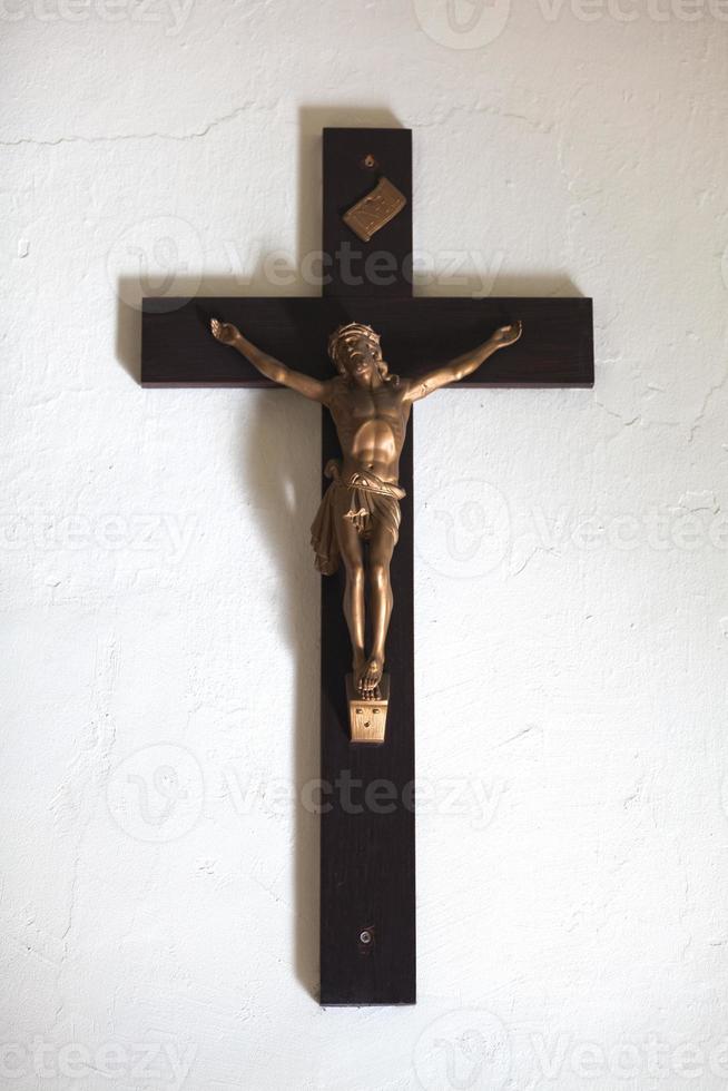 Wooden crucifix with a brass Jesus Christ. photo