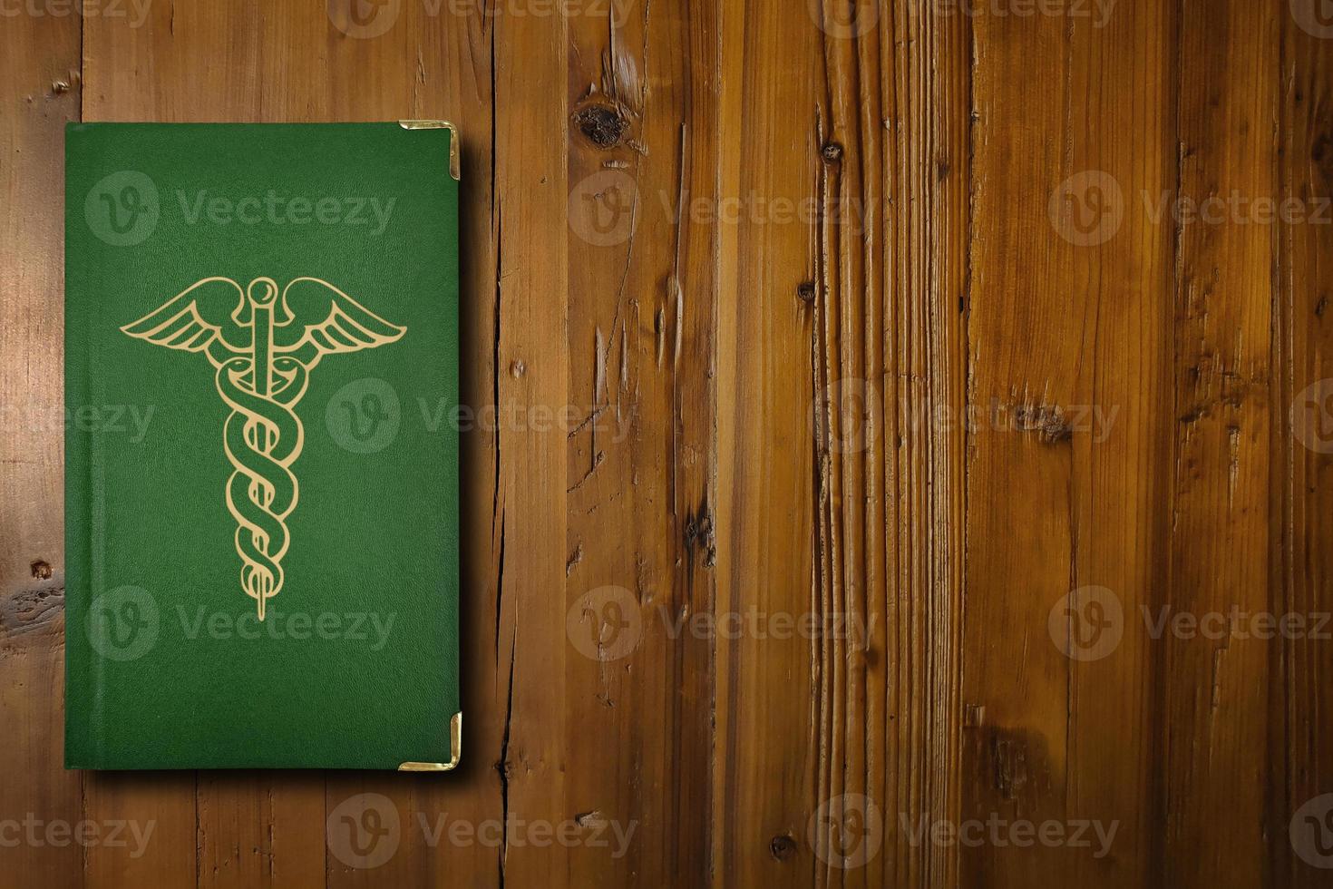 Medical book on a wooden desk photo