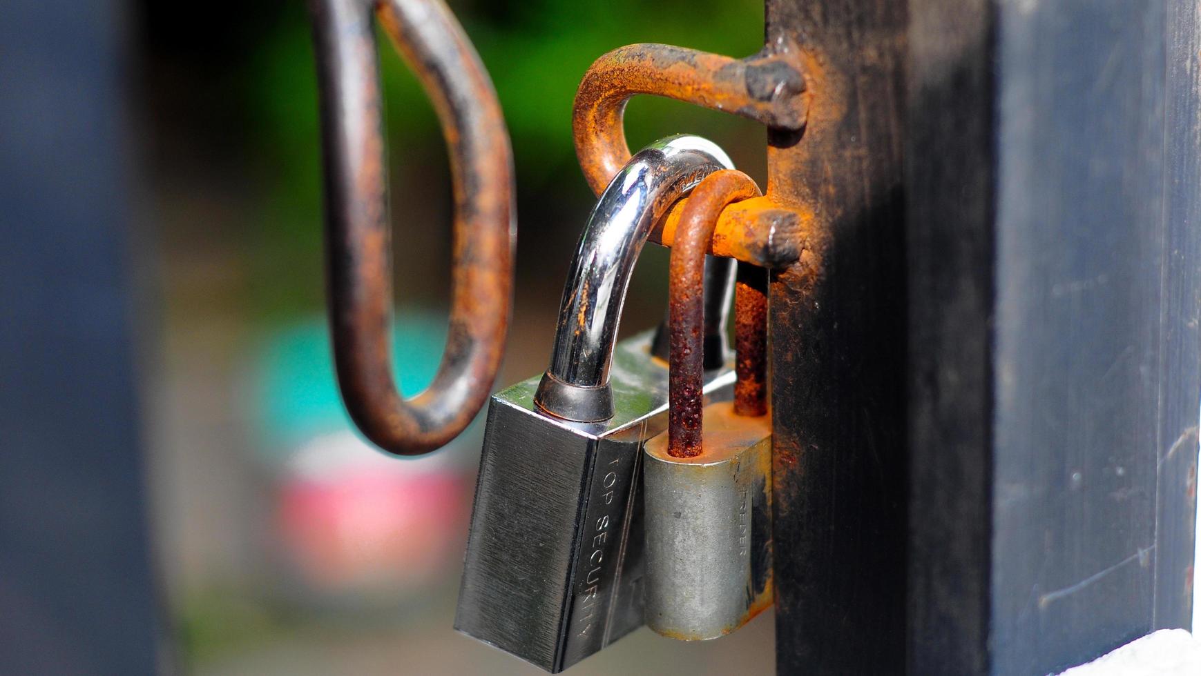 old rusty padlock on the background of the house photo