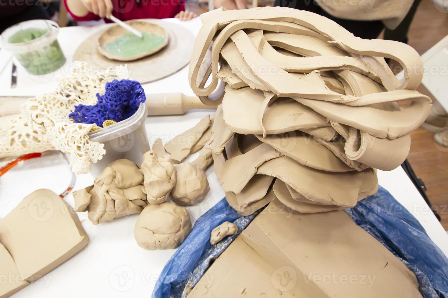 Clay master class. A large piece of clay for making pottery. Potter's work table. photo