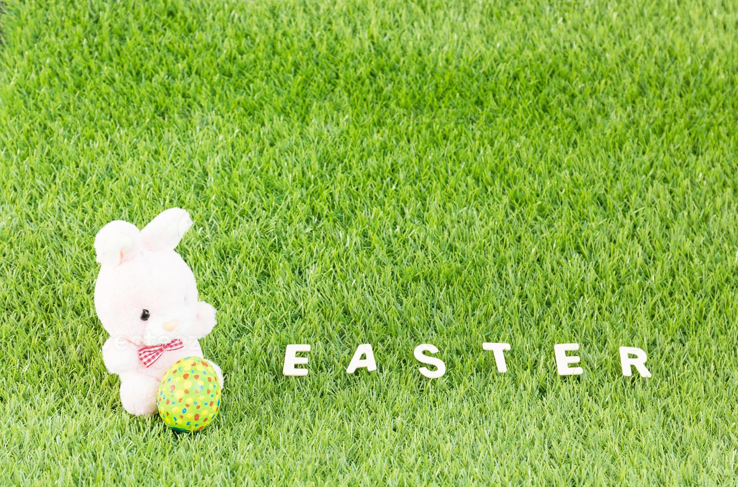 Bunny toy and Easter eggs with text photo