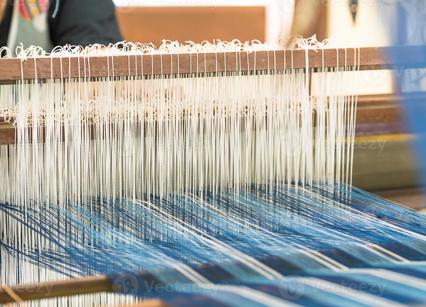 Weave silk cotton on the manual wood loom photo
