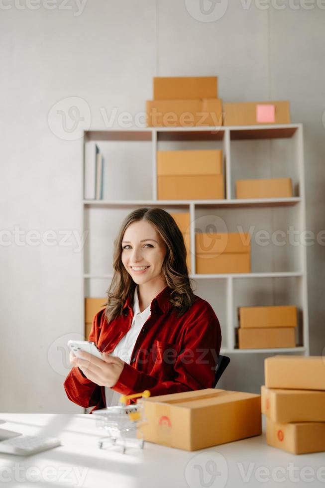 Small business entrepreneur SME freelance woman working at office, BOX,tablet and laptop online, marketing, packaging, delivery,  e-commerce concept photo