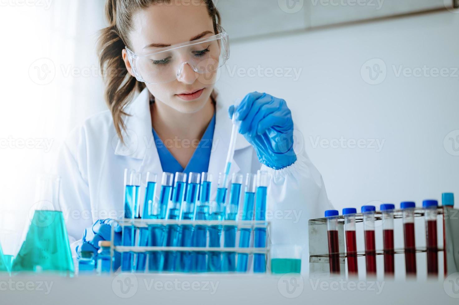 Female scientist researcher conducting an experiment in a laboratory. photo