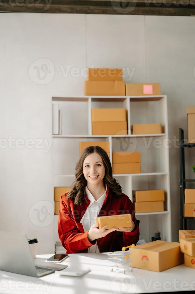 Small business entrepreneur SME freelance woman working at office, BOX,tablet and laptop online, marketing, packaging, delivery,  e-commerce concept photo