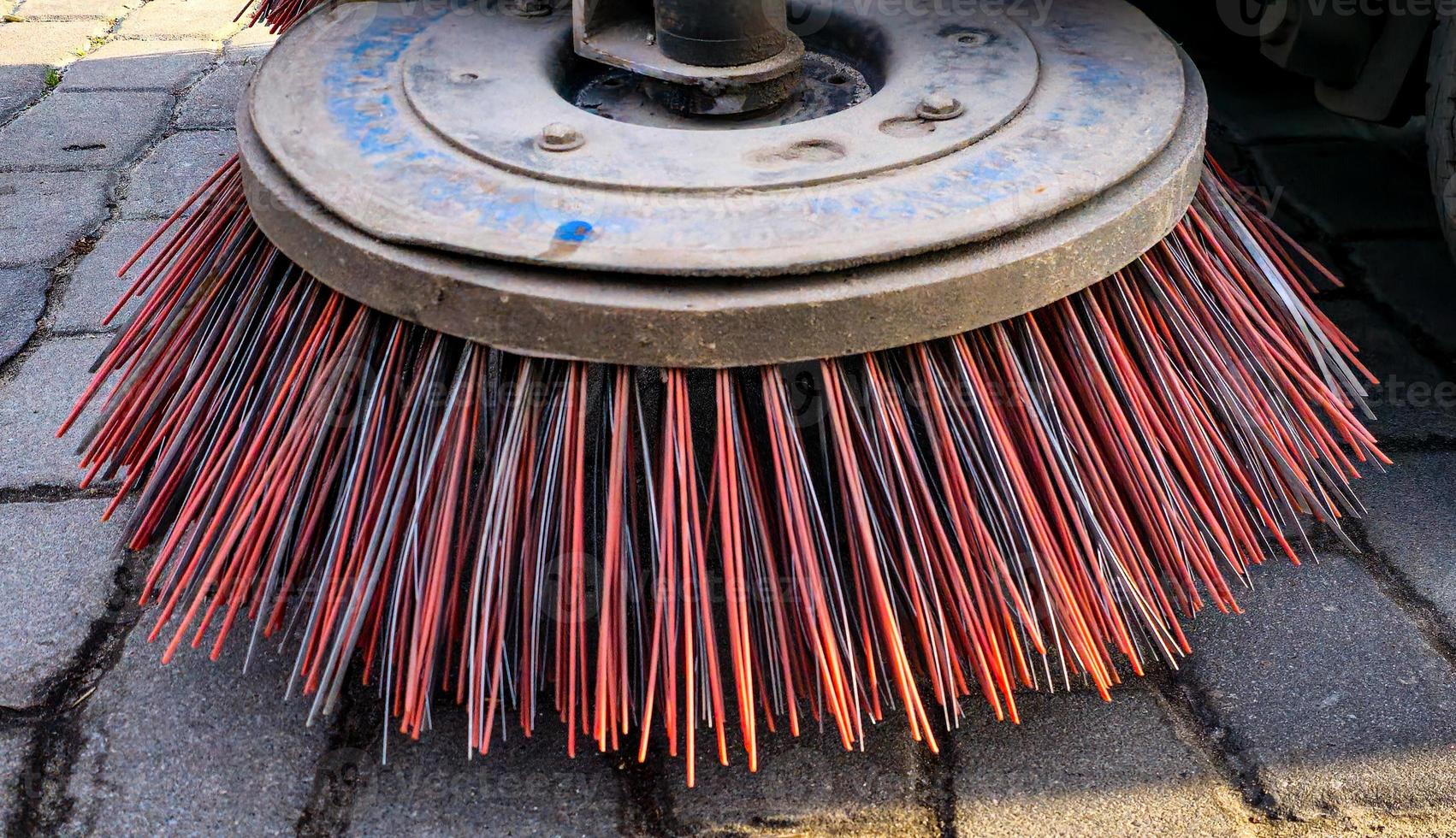 Close-up sweeper machine cleaning. Concept clean streets from debris. photo