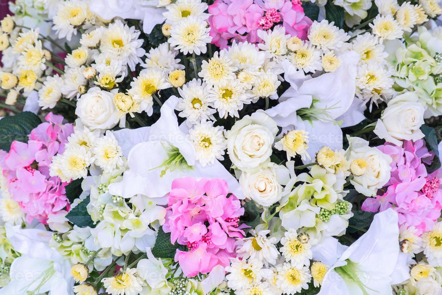 Floral background. Lot of artificial flowers in colorful composition photo