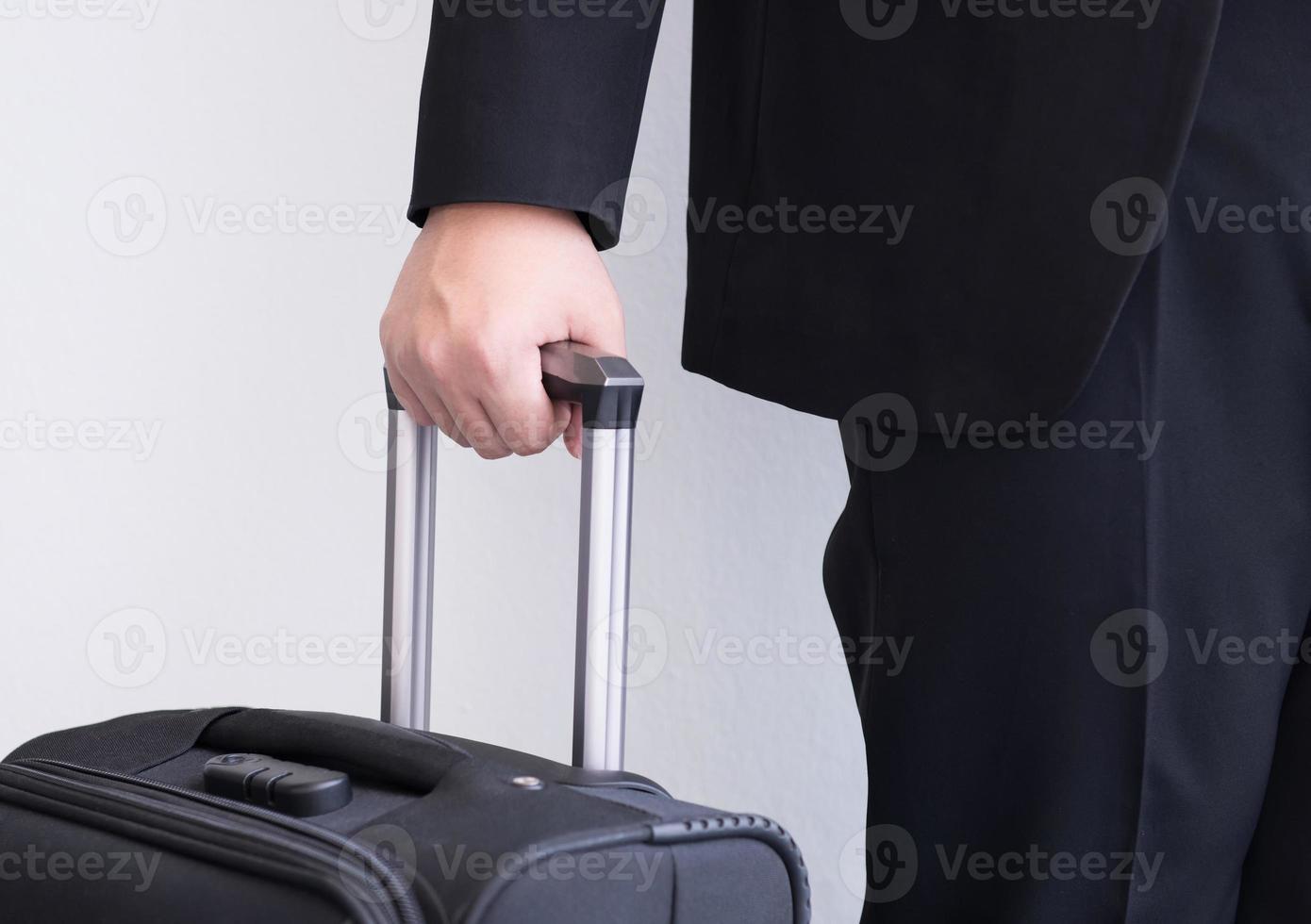 Male's hand hold baggage for travelling photo