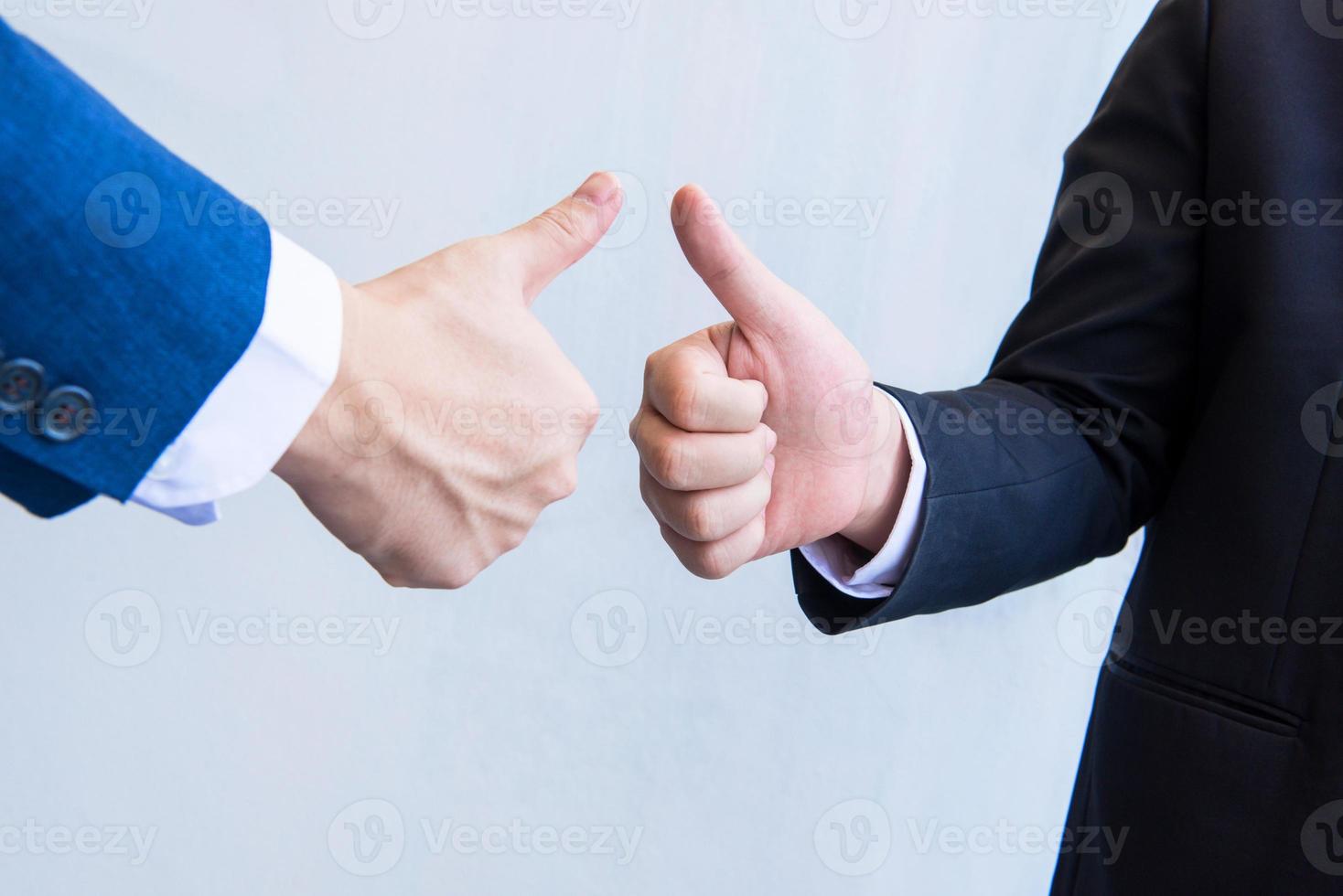 Two male hands showing thumbs up photo