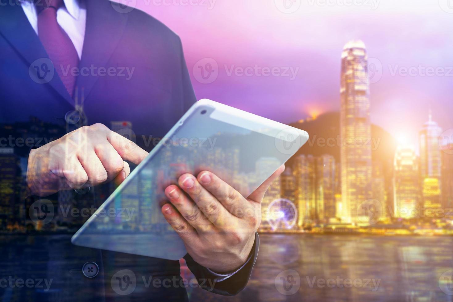 Business man holding tablet on blurry background. photo