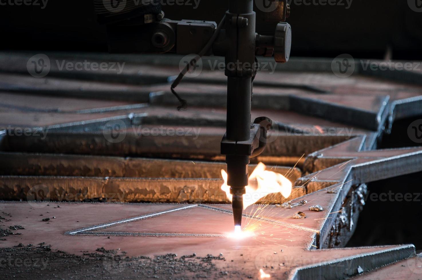 Oxy-fuel welding machine cutting metal in the factory photo