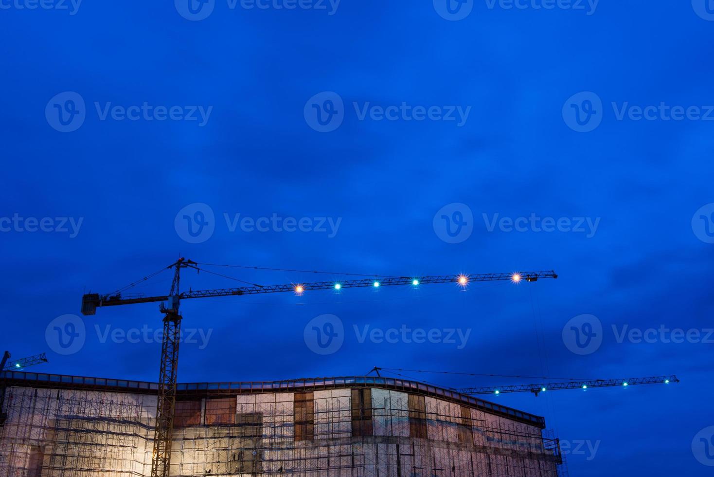 Construction site with cranes in twilight time photo