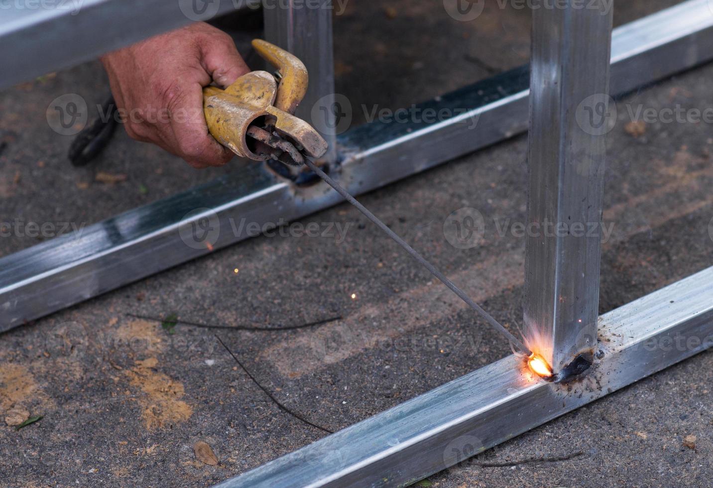 Arc welding of a steel at work site photo