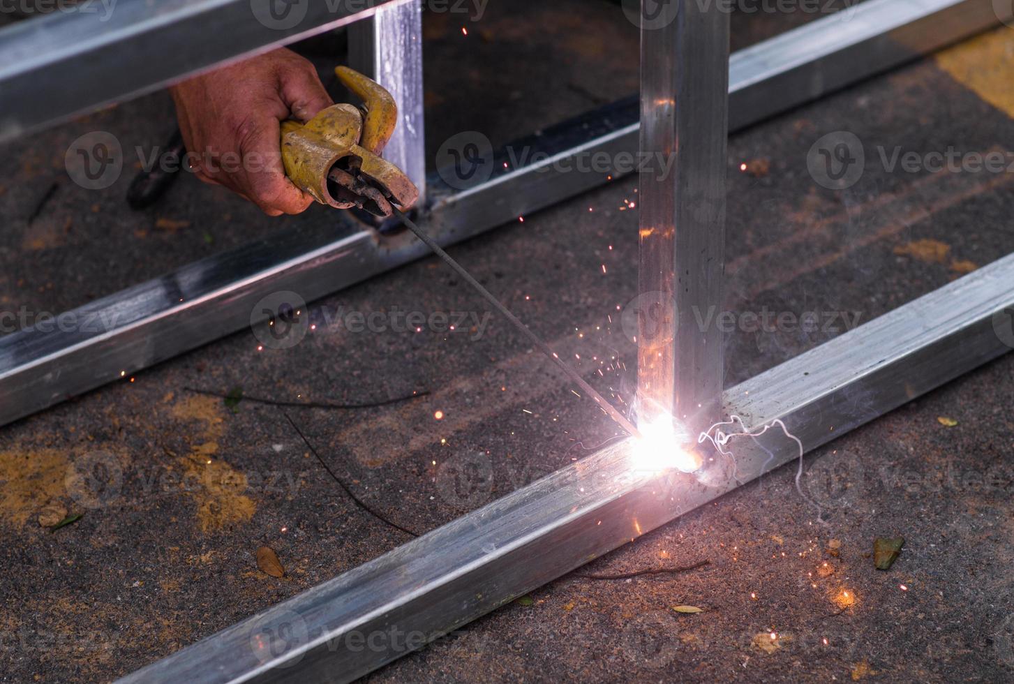 Arc welding of a steel at work site photo