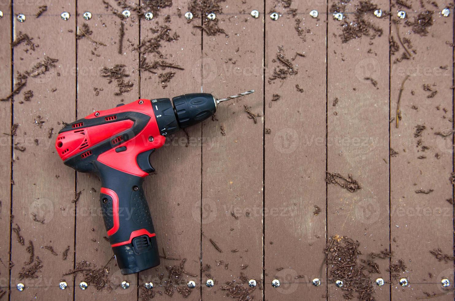 electric drill on wooden floor photo