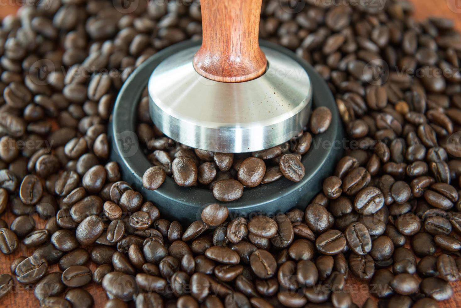 coffee tamper and roasted coffee in rubber base photo