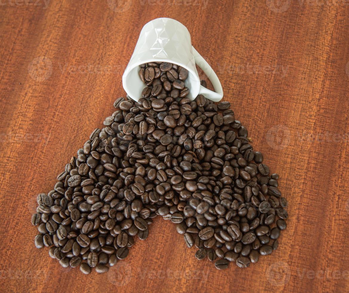 Coffee bean as a heart on wooden table photo