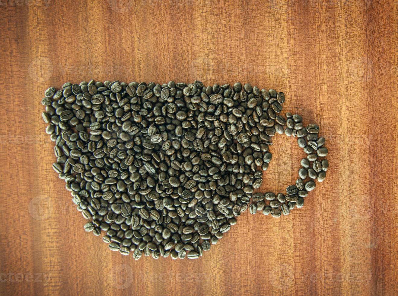 Coffee bean as a cup on wooden table photo
