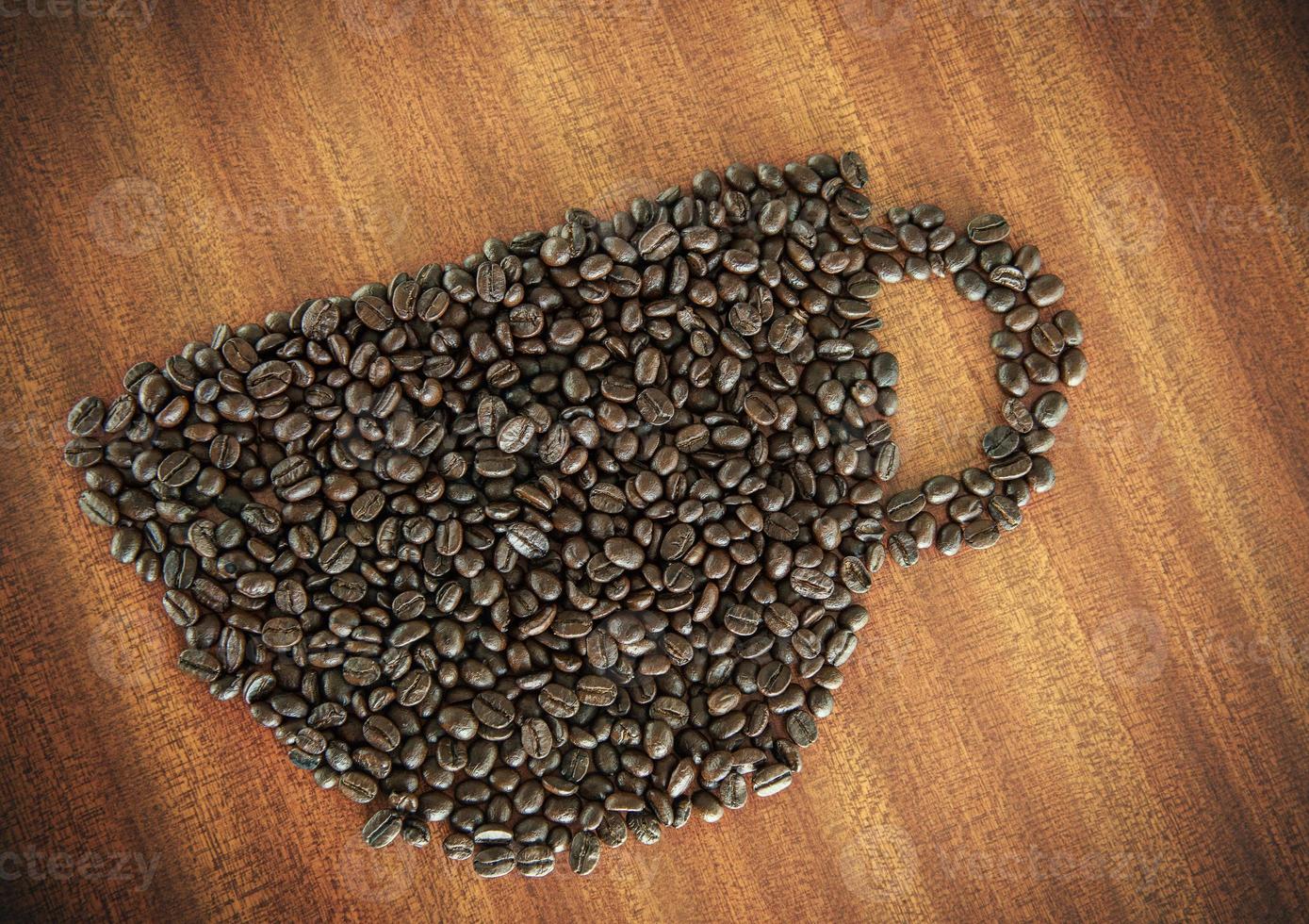 Coffee bean as a cup on wooden table photo