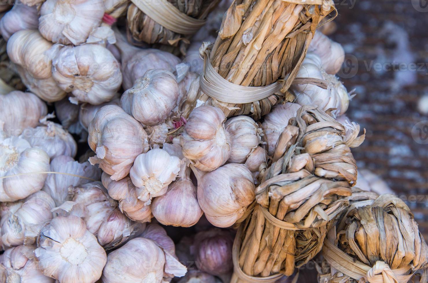 Garlic Cloves and Garlic Bulb on wooden rack photo