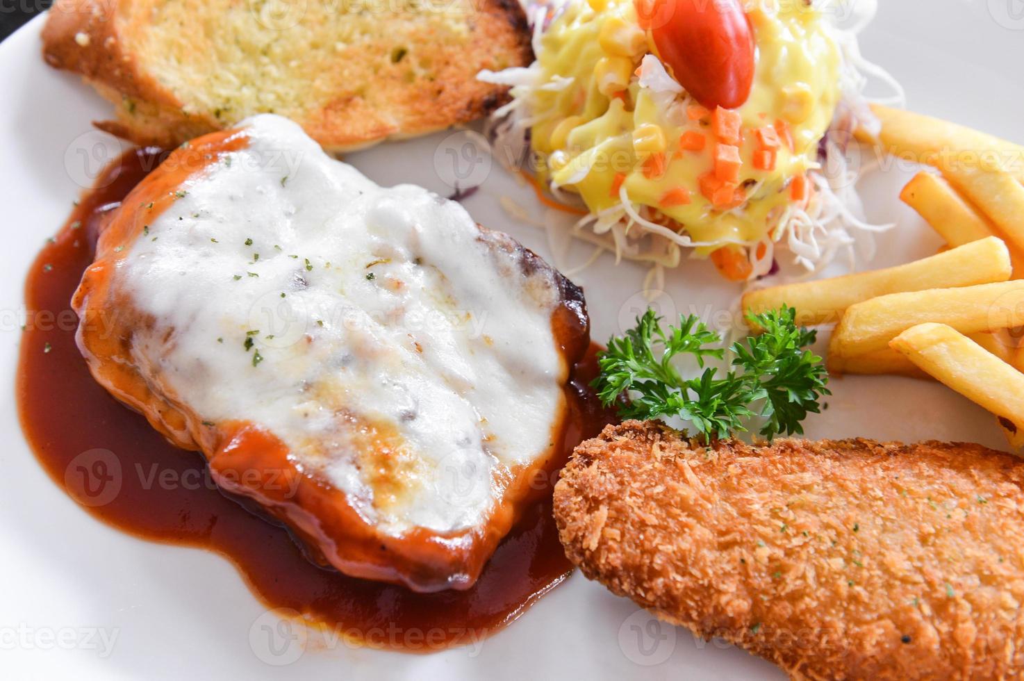 Chicken Steak and fried fish with salad and chips photo