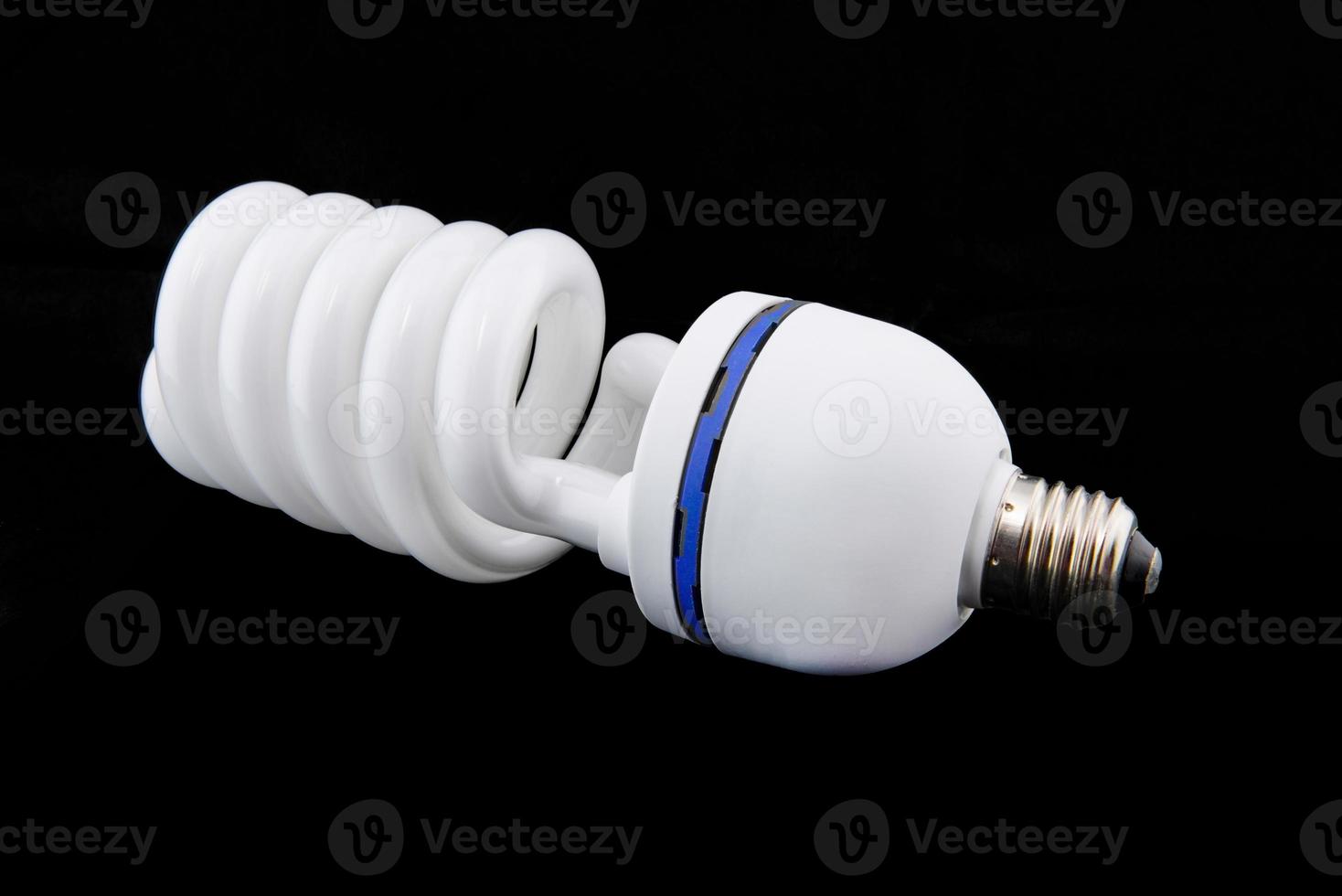 white energy saving bul or Illuminated light bulb on black background photo