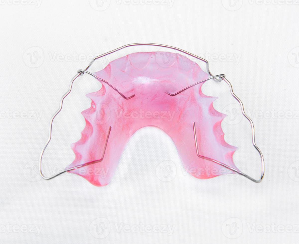 Retainer and brace on white background photo