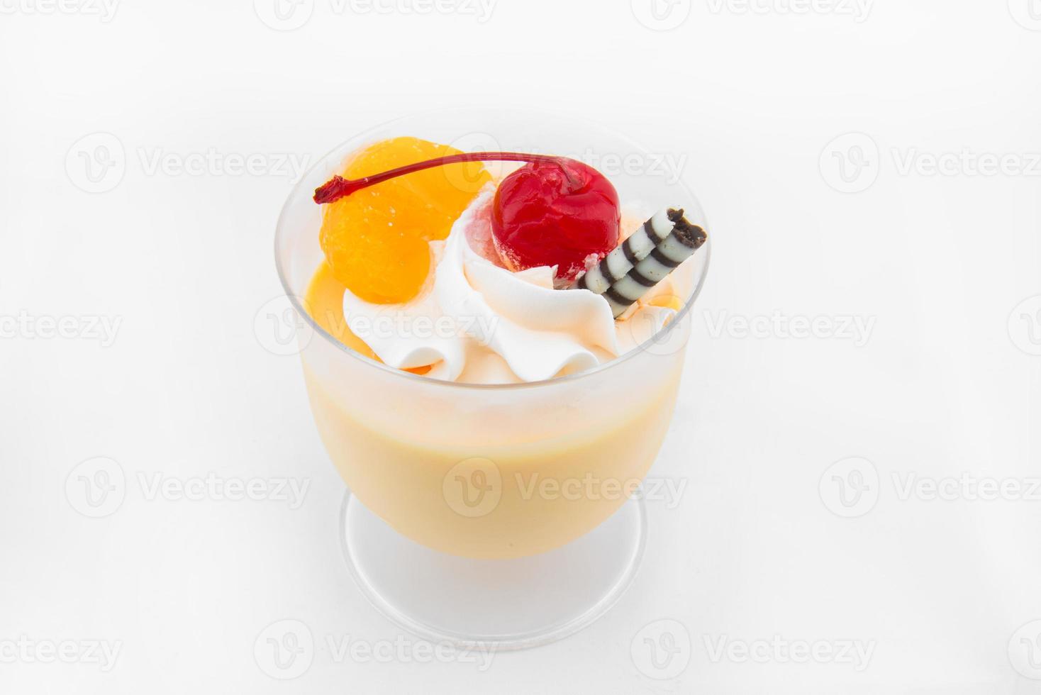 Orange Mousse with red cheery in glass photo