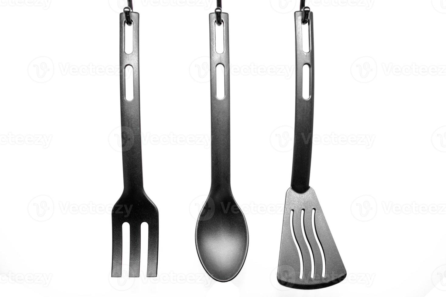 black kitchen utensils on white background photo