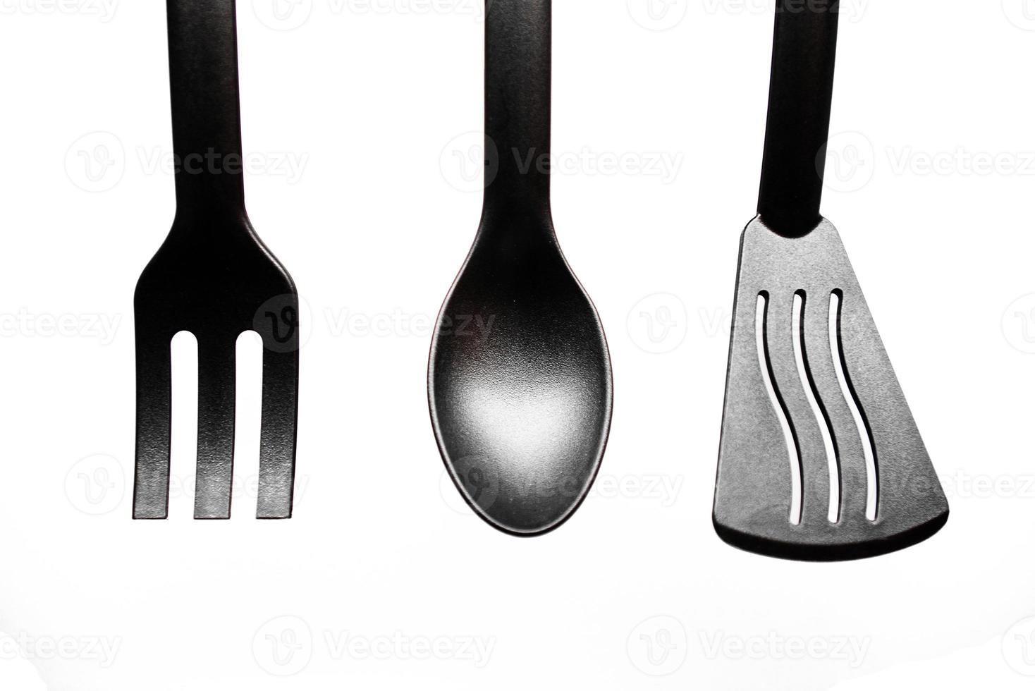 black kitchen utensils on white background photo