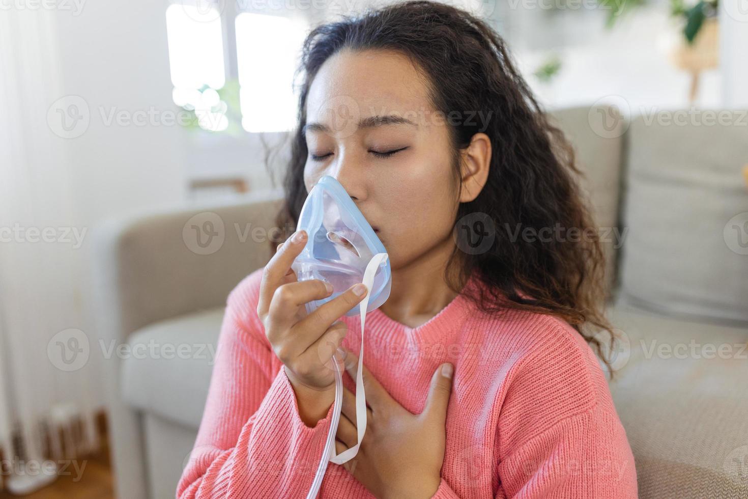 Sick Asian woman making inhalation, medicine is the best medicine. Ill woman wearing an oxygen mask and undergoing treatment for covid-19. woman with an inhaler photo