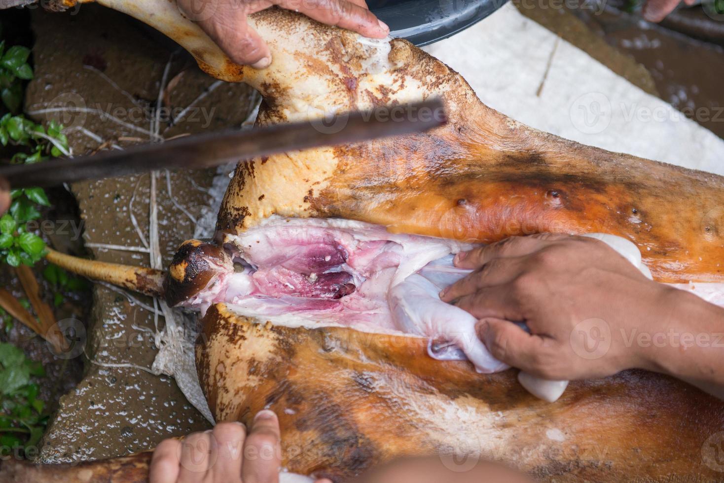 cutting up pork with knife photo
