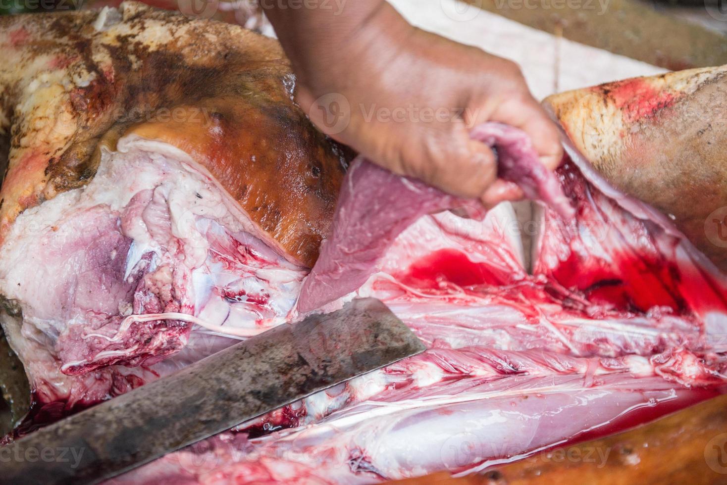 slicing pork with knife photo