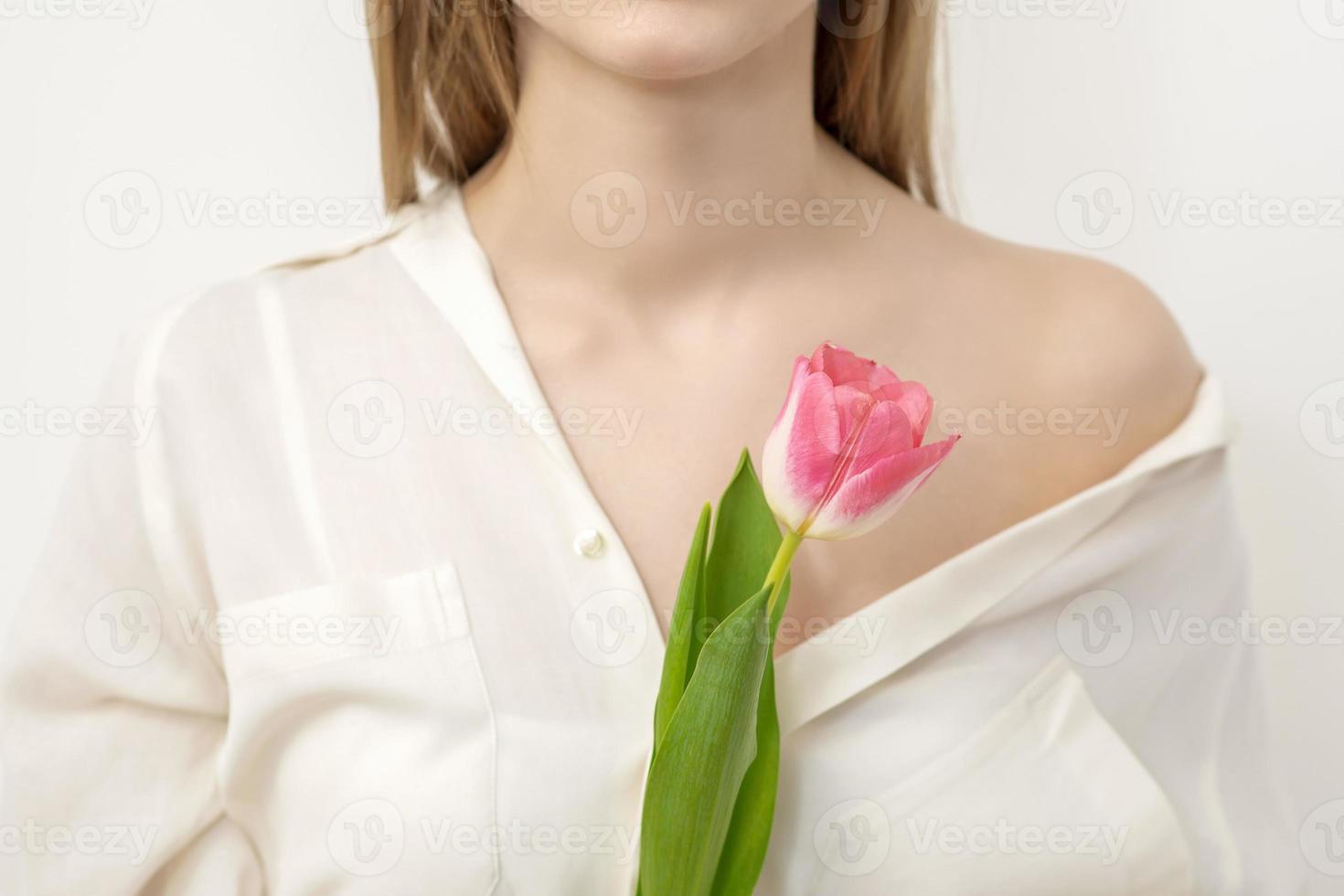 Young woman with one tulip photo