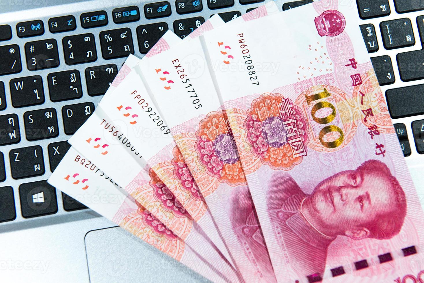 Yuan or RMB, Chinese Currency on laptop's keyboard photo